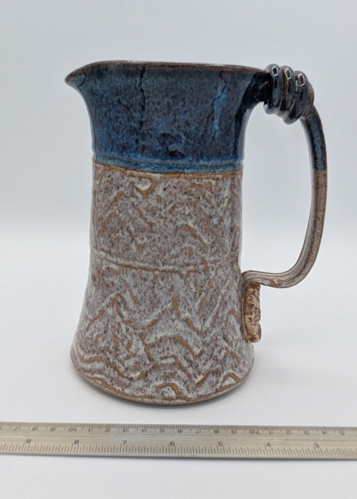 Robust Handcrafted Ceramic Pitcher with Textured Body and Cobalt Blue Rim