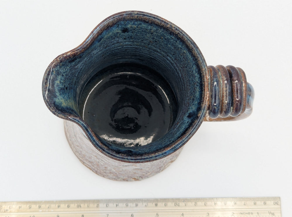 Robust Handcrafted Ceramic Pitcher with Textured Body and Cobalt Blue Rim