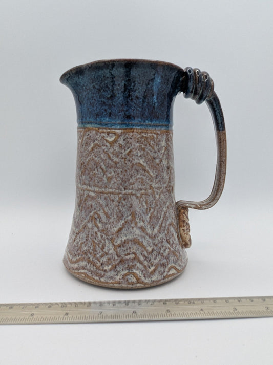 Robust Handcrafted Ceramic Pitcher with Textured Body and Cobalt Blue Rim