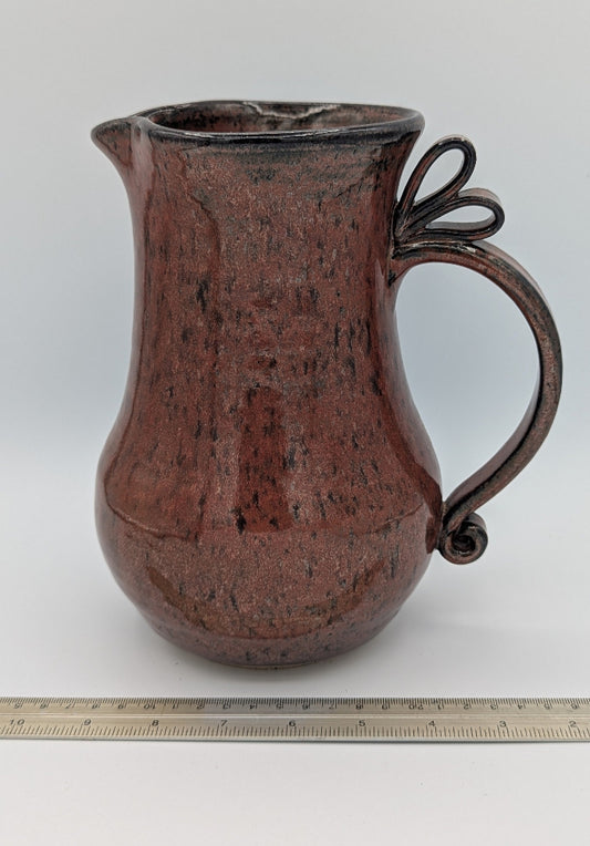 Artisan Handcrafted Pitcher with Decorative Handle in Rich Rust Glaze